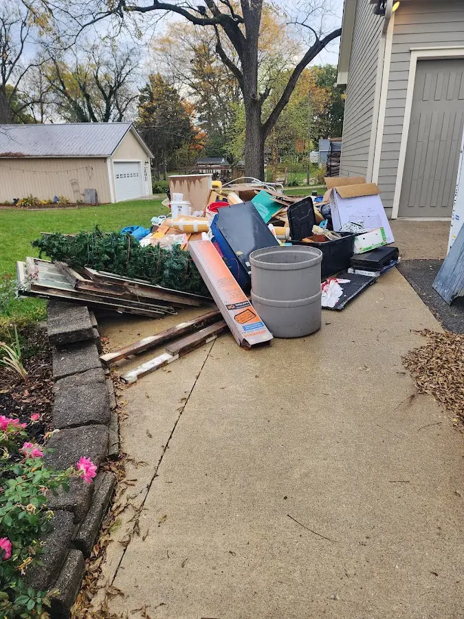 Dumpster being loaded with debris for 10 Yard Dumpster Rental in Lenexa
